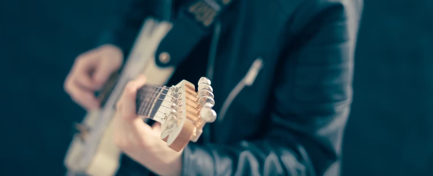 Drive 105 musician playing guitar in studio atmosphere
